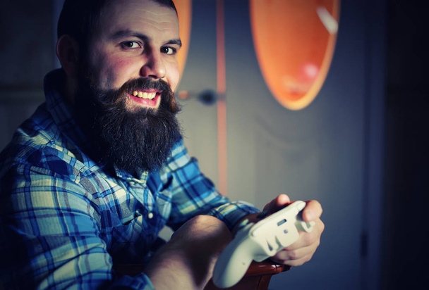 man bearded play joystick - Foto, immagini
