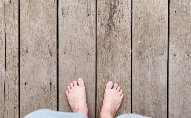 aerial view of barefoot with short pants stand on grunge wood pl - Photo, Image