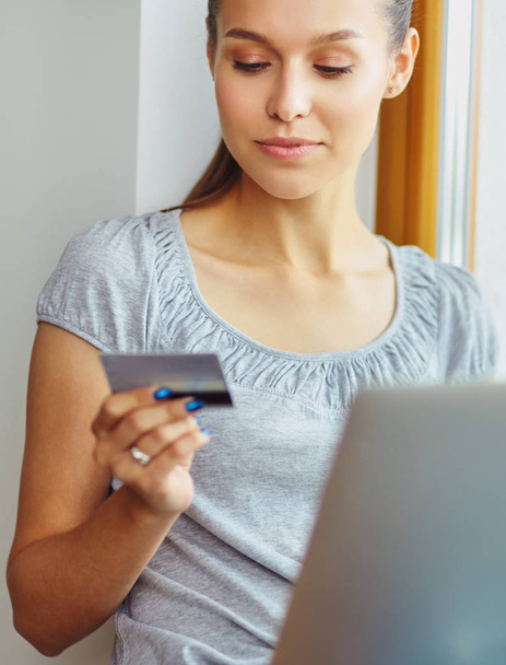 Young beautiful woman using a laptop computer at home - Photo, Image
