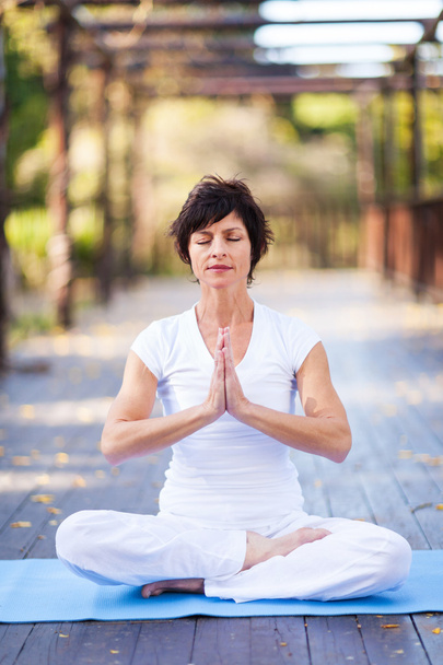 Middle aged woman yoga meditation - Foto, afbeelding