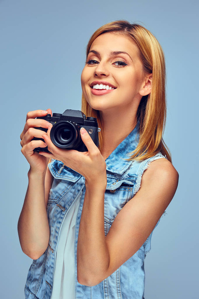 Girl holds digital photo camera - Photo, Image