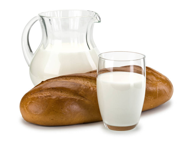 Glassware filled with milk and a white loaf long loaf - Φωτογραφία, εικόνα