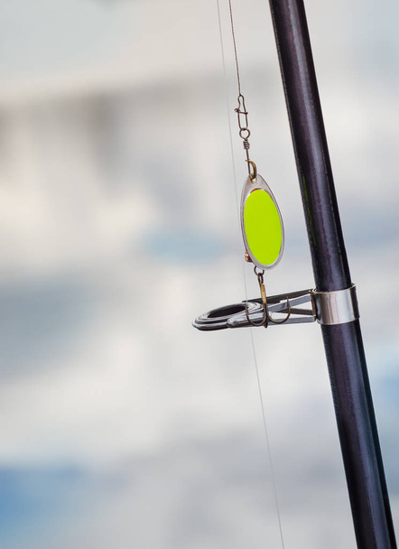 Fishing baubles closeup on the rod - Фото, изображение