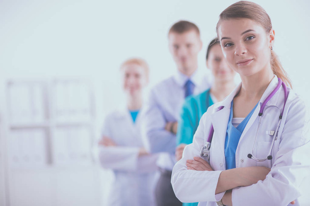 Attractive female doctor in front of medical group - Foto, Imagem