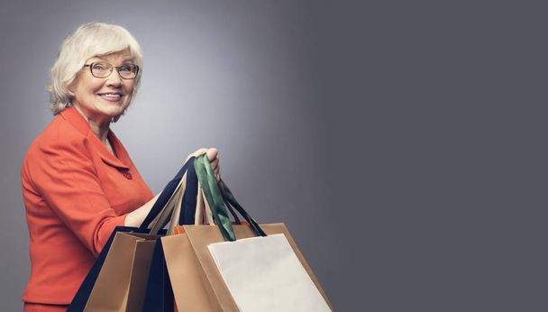 Senior lady with shopping bags - Foto, Imagen
