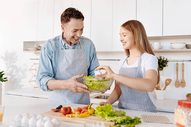 Positive smiling father and daughter having fun in the kitchen - Fotoğraf, Görsel