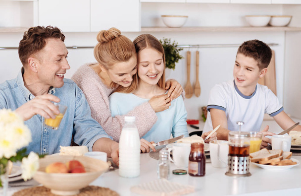 Positive family enjoying breakfast together - Foto, imagen
