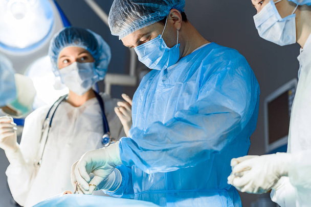 Serious medical workers operating person - Photo, Image