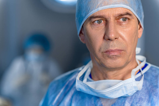 Sad male surgeon glancing despondently - Photo, image