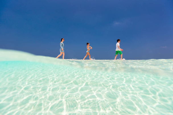 Mother and kids at tropical beach - 写真・画像