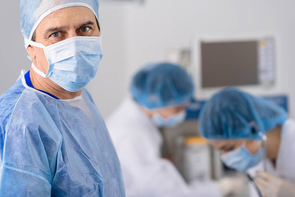 Confident male doctor in operating theatre - Photo, image