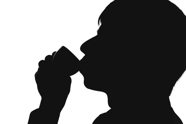 silhouette of a man drinking coffee - Zdjęcie, obraz