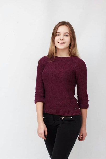 Portrait of a young attractive woman in red sweater - Foto, Imagen