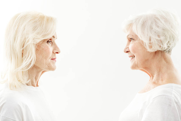 Joyful mature female friends are satisfied by their appearance - Photo, image