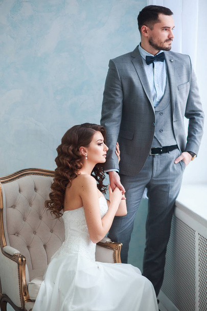 A woman holding a mans hand. Bride in beautiful dress and groom - Photo, Image