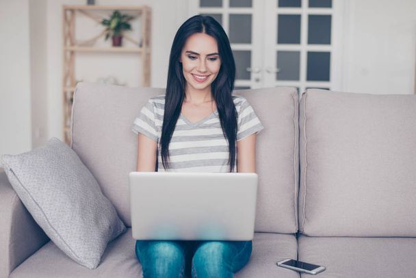 Successful smart beautiful young woman sits at home on the couch - Photo, image