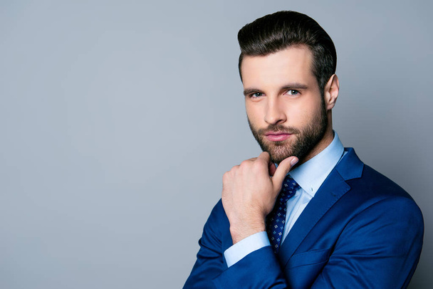 Portrait of serious fashionable handsome man in blue suit and ti - Foto, immagini
