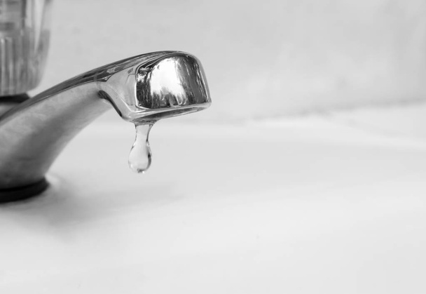 Closeup tap with water dropping, black and white color tone - Photo, Image