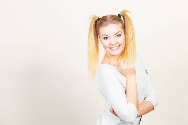 Happy blonde teenager girl with ponytails - Фото, изображение