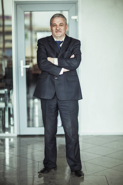 portrait of a successful businessman on background of modern office - Фото, изображение