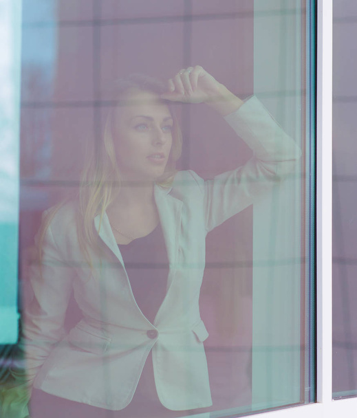 successful woman leader looks out the window of his personal office - Foto, Imagen