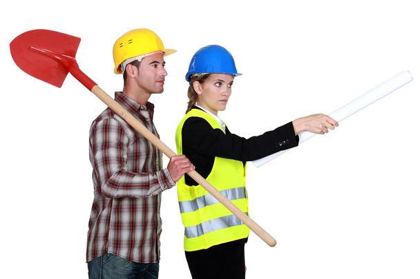 Building worker and woman supervising work on white background - Foto, imagen