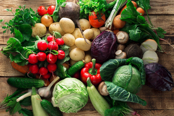 Set of different vegetables on a wooden table close up - Foto, imagen