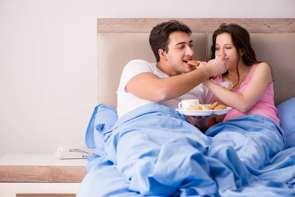 Happy family having breakfast in bed - Photo, Image
