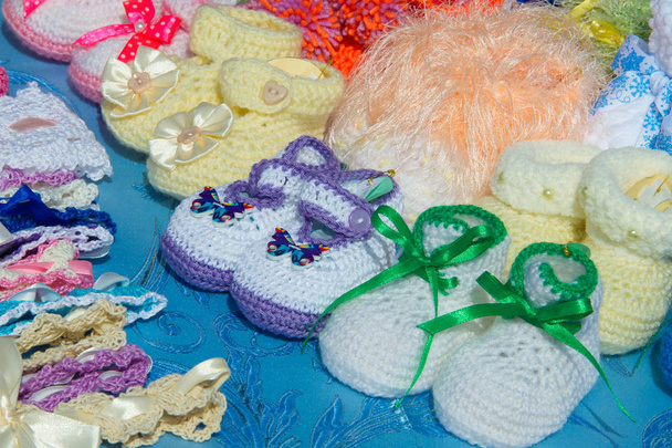 Texture, background, pattern. Baby booties, shoes for babies. Shoes with soft soles for toddlers - Photo, Image