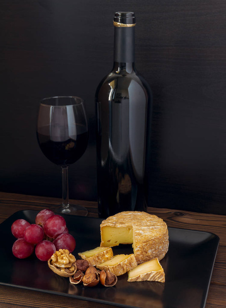Soft washed-rind cheese and wine  - Photo, Image