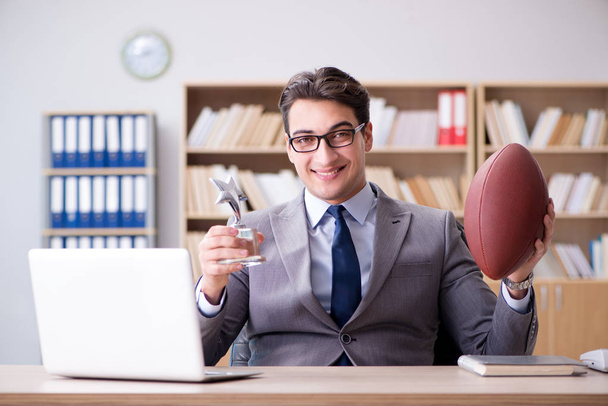 Businessman with american football in office - Zdjęcie, obraz