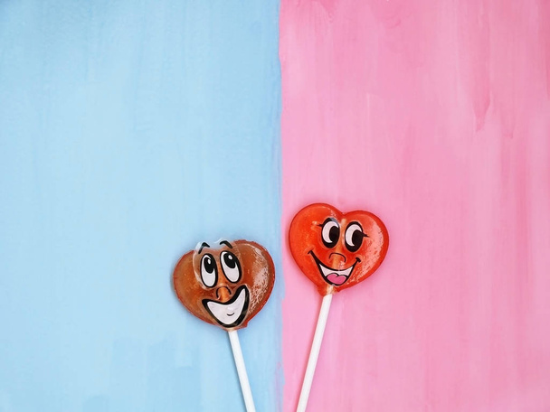 Two lollipops on pink and blue background. Love concept. Valentines day - Fotoğraf, Görsel