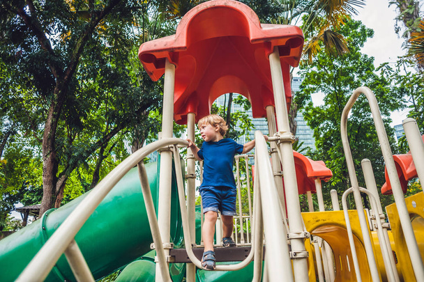 little kid boy playing at playground.  - Фото, изображение
