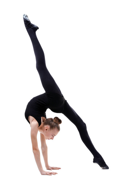 Young girl doing gymnastics on white background - Zdjęcie, obraz
