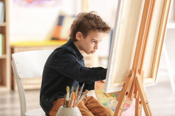 Cute little artist painting picture in studio - Photo, image