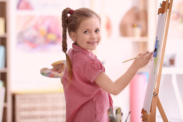 Cute little artist painting picture - Фото, изображение