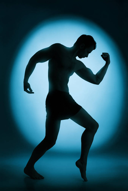 Silhouette of bodybuilder - Фото, зображення