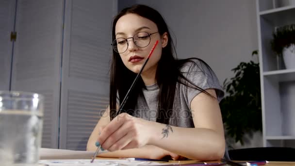 female artist drawing artwork at home with brush - Filmati, video