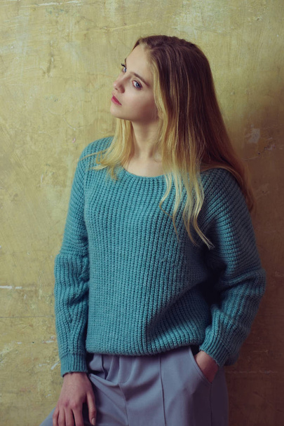 Pretty young girl with blond hair in fashionable sweater, culottes - Foto, immagini
