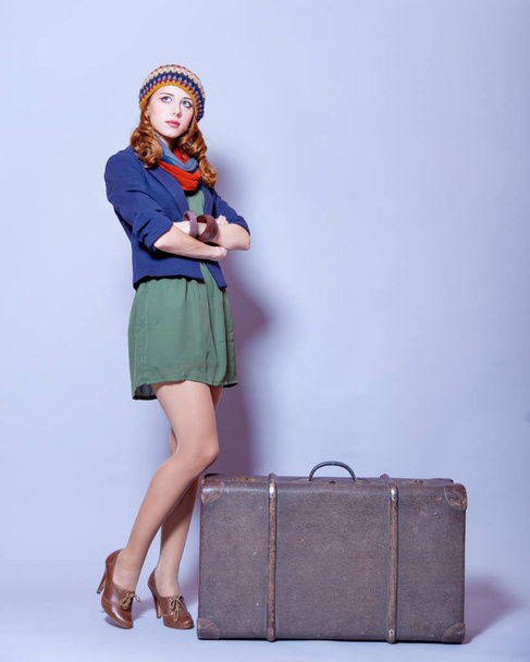 photo of beautiful young woman standing near suitcase on the won - Foto, Imagem