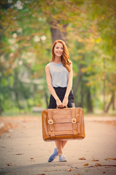 Φωτογραφία: όμορφη νεαρή γυναίκα με βαλίτσα για το εξαιρετικό au - Φωτογραφία, εικόνα
