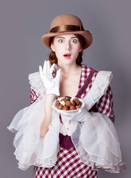 photo of beautiful young woman in vintage dress with plate full  - Φωτογραφία, εικόνα