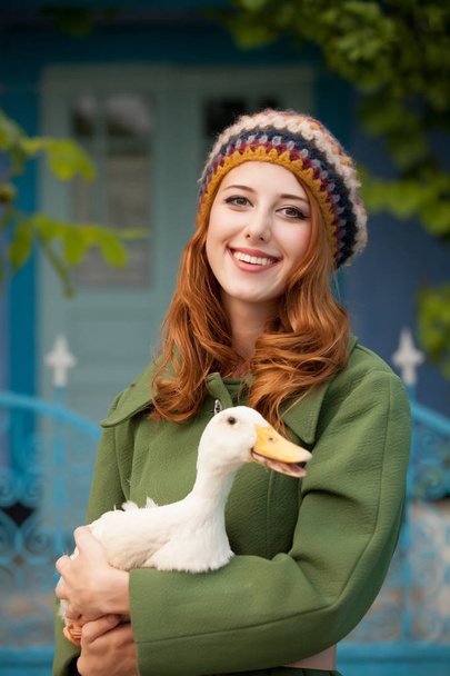 photo of beautiful young woman with goose on the wonderful build - Valokuva, kuva
