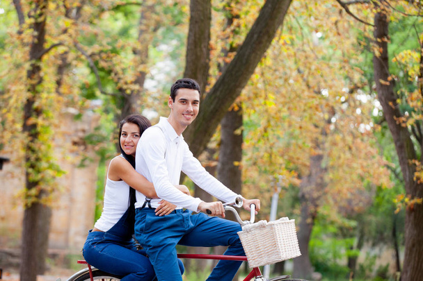 photo of cute couple sitting on bicycle and hugging on the wonde - Foto, Imagem
