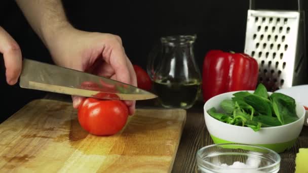 Knife Cuts Tomato On Wooden Board - Záběry, video