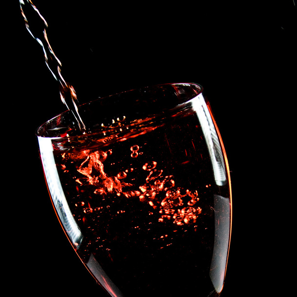 Glass of wine on a black background - Φωτογραφία, εικόνα
