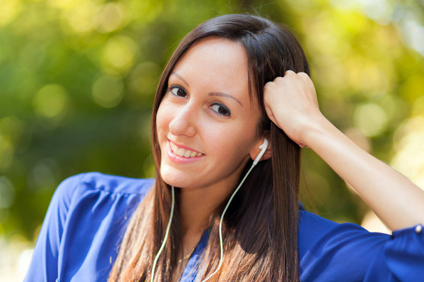 woman listening music outdoors  - Photo, Image