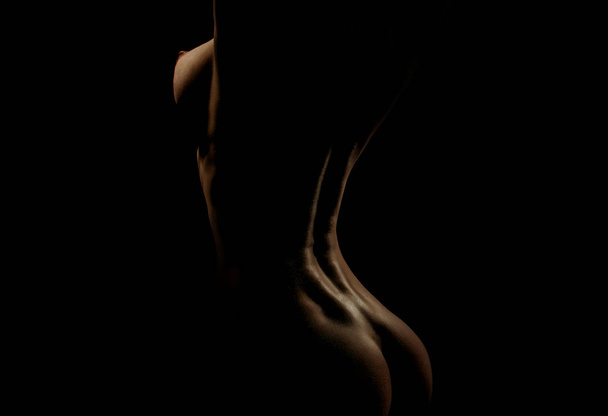 sexy woman with naked chest and buttocks on black background - Photo, image