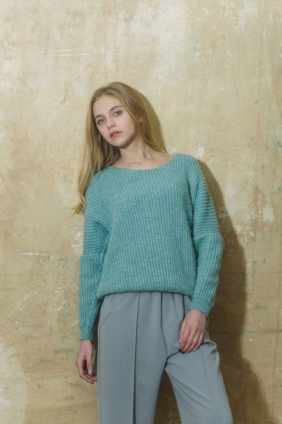 Pretty young girl with blond hair in fashionable sweater, culottes - Valokuva, kuva