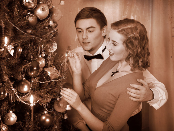 Couple ignites candles on Christmas tree. - Valokuva, kuva